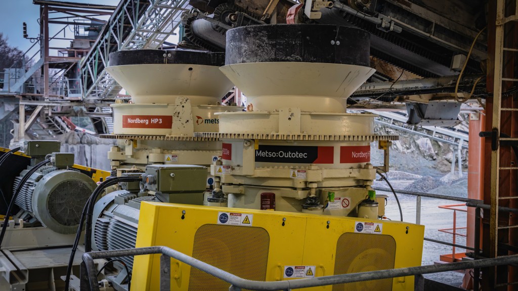 Two cone crushers operate on a job site