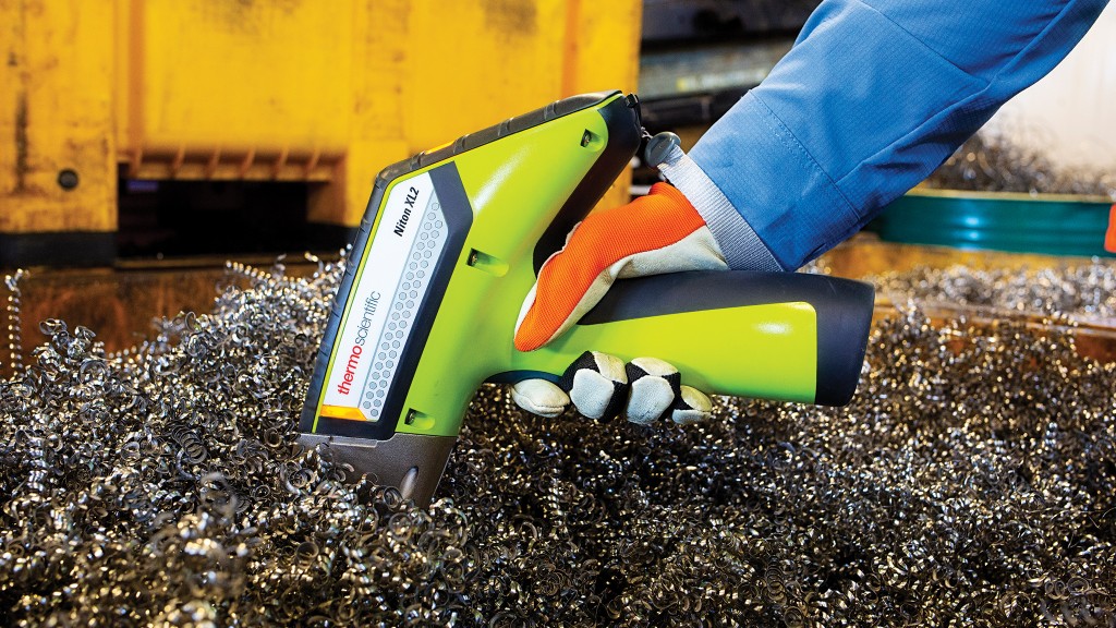 A material analyzer scans a chunk of scrap metal