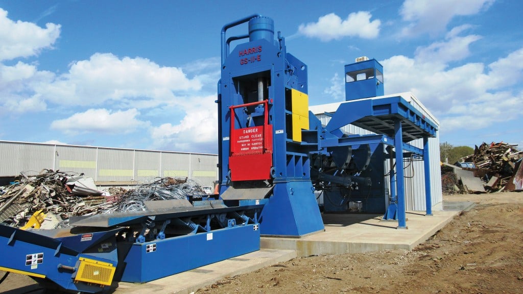 A shear/baler/logger operates in a recycling facility