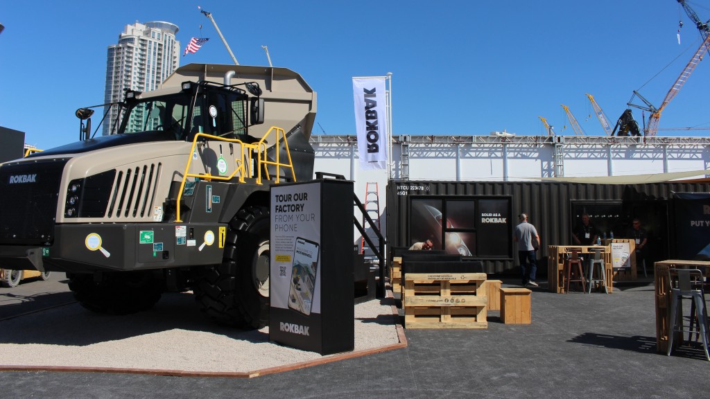 An articulated hauler parked at a trade show