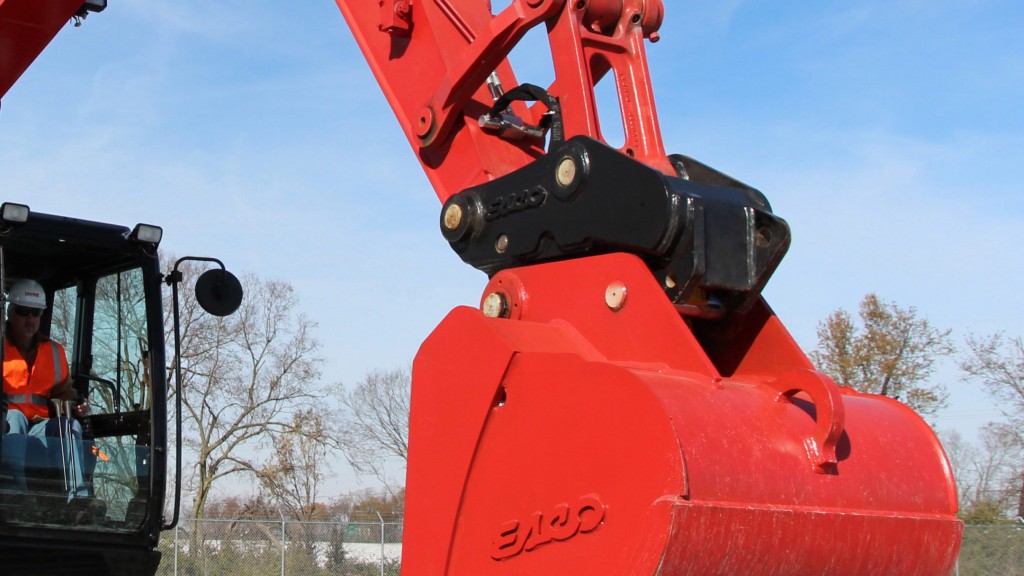 A hydraulic coupler holding a bucket attached to an excavator.