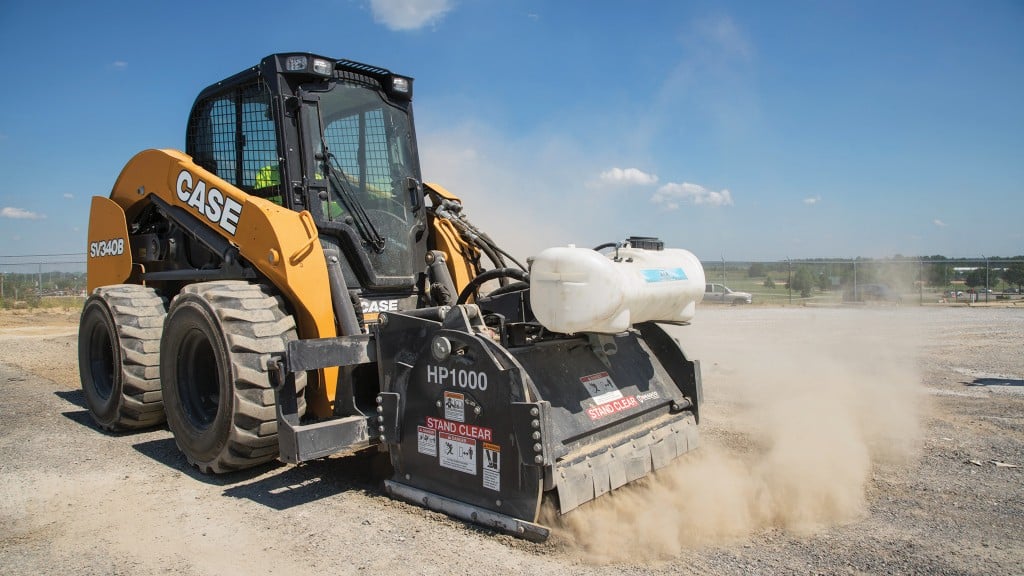A compact track loader utilizes a hydraulic attachment on the job site