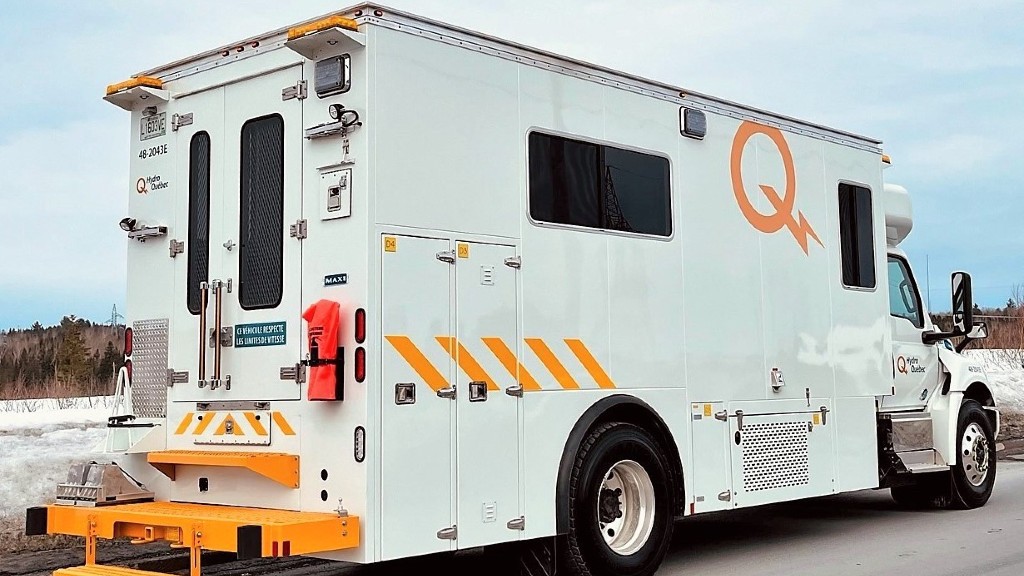 An electric truck is parked at the side of a road