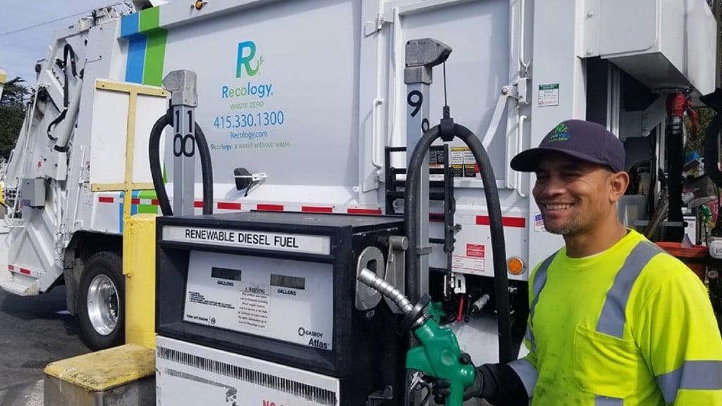 A driver fills a truck with renewable diesel fuel