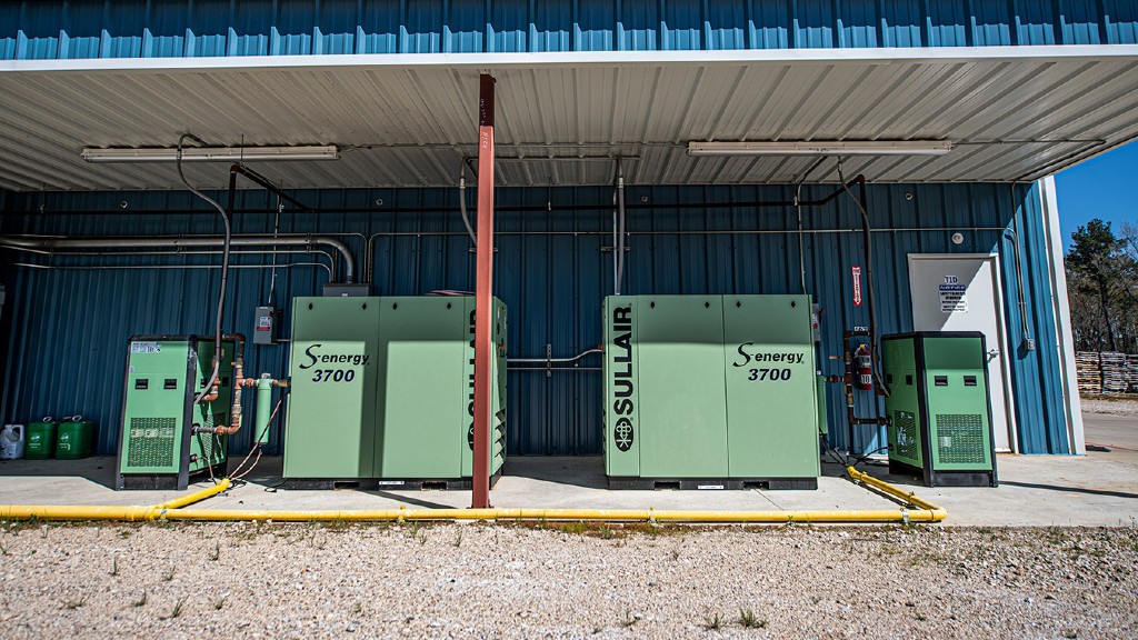 Industrial air compressors on the side of a building