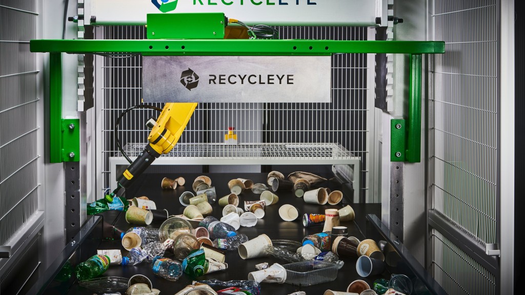 A robot picks recyclables on a moving conveyor