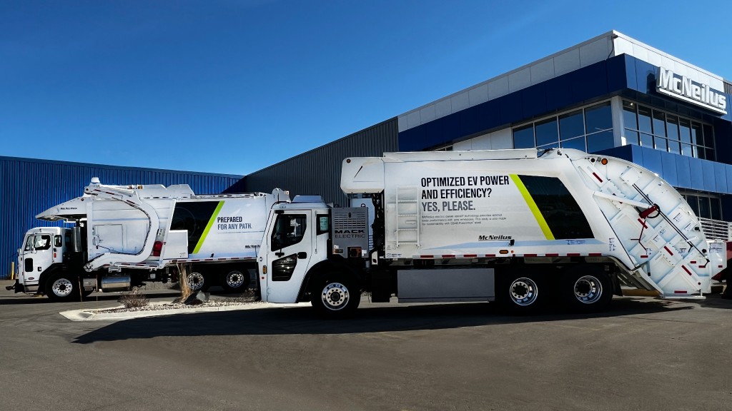 A collection truck parked near a building