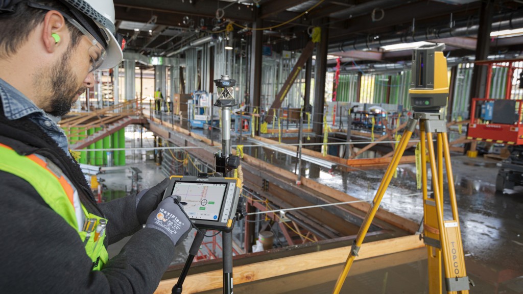 A construction worker uses a digital layout software