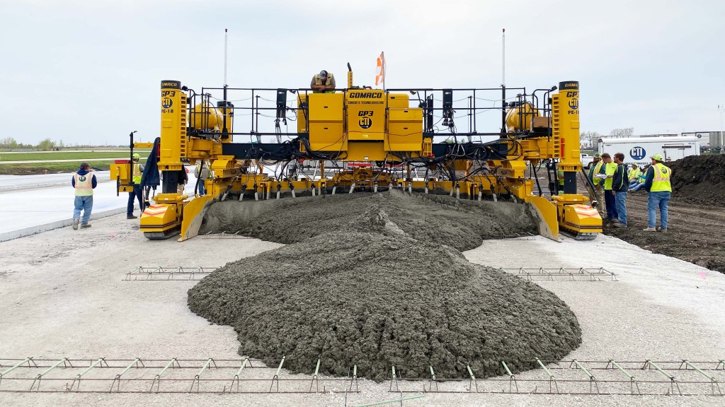 A slipform paver lays down a line of concrete