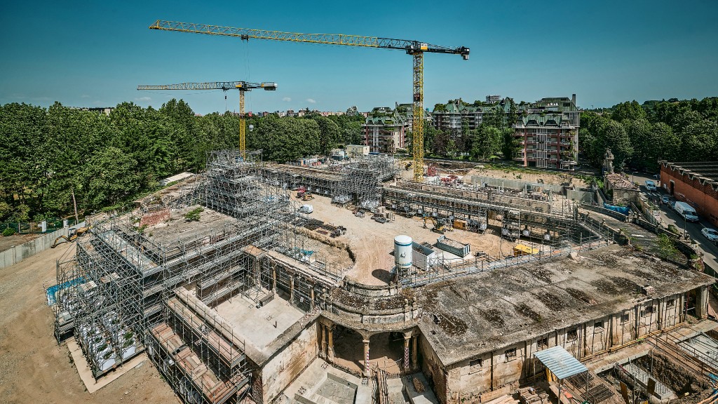 Two cranes work at a construction site