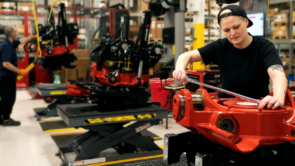 Workers assemble tiltrotators inside a facility