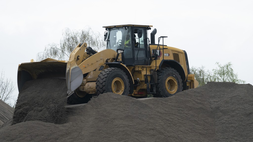 A wheel loader working in a gravel pile.