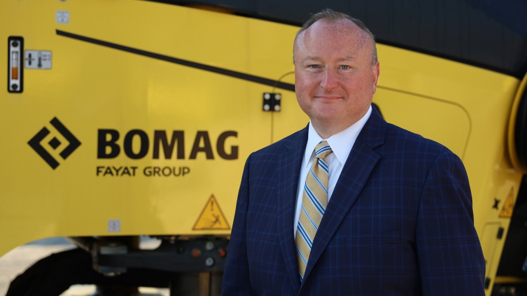 Brian Bieller stands near a BOMAG machine