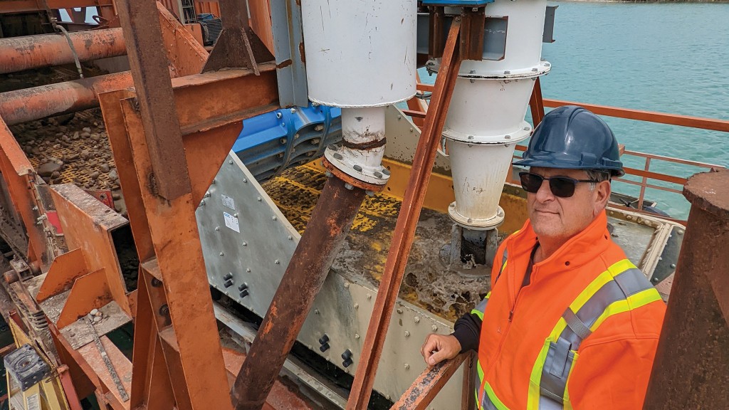 Bruno Giordano stands on a dredge unit in operation