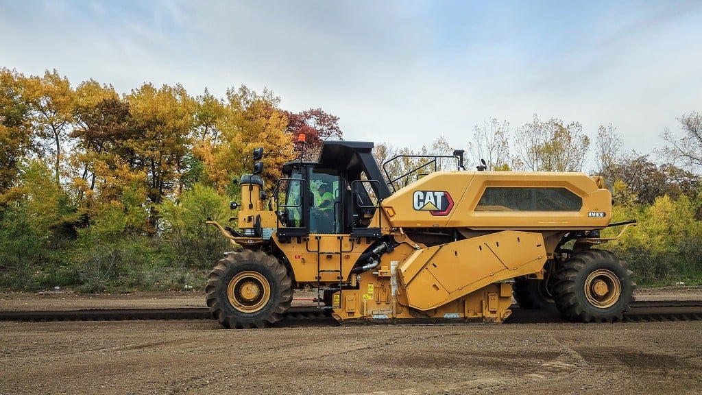 A reclaimer/stabilizer working across a flat dirt surface.