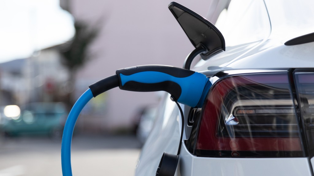 An EV charges parked by the side of the road