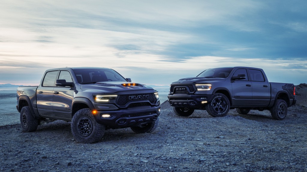 Two pickup trucks are parked on a rocky outcropping