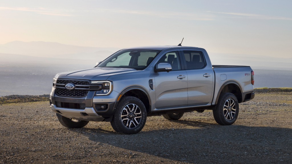 A pickup truck is parked near a cliff