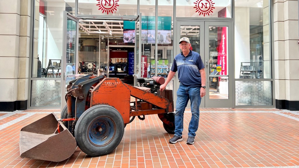 Joe Keller stands next to a three-wheel loader