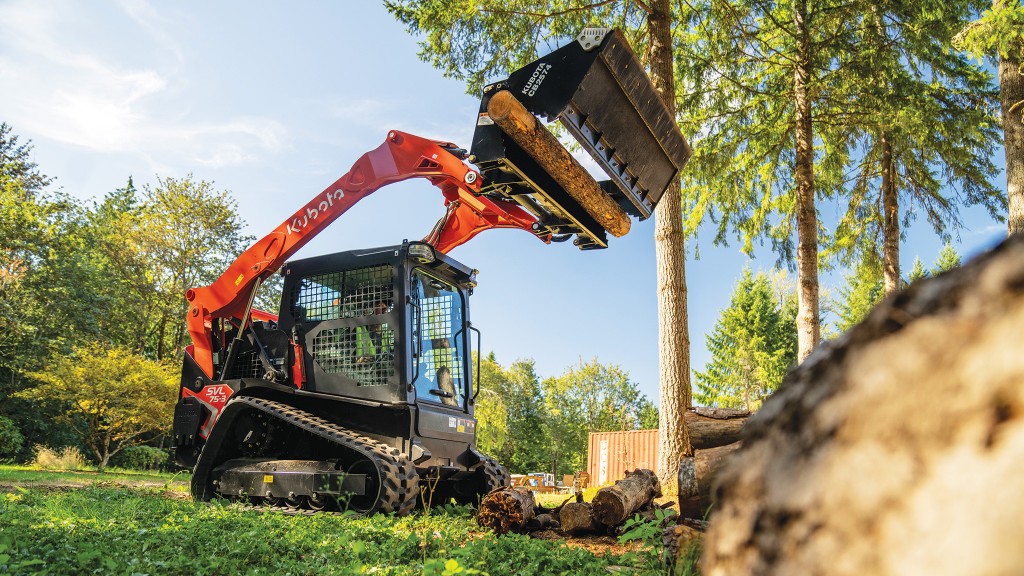 A compact track loader lifts its bucket up high