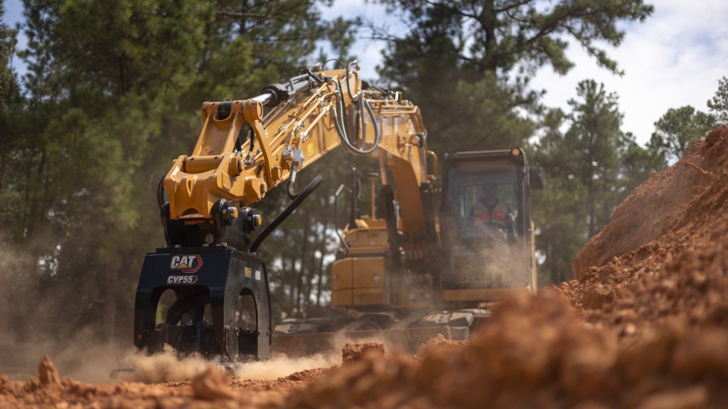 A vibratory plate compacts dirt on a job site