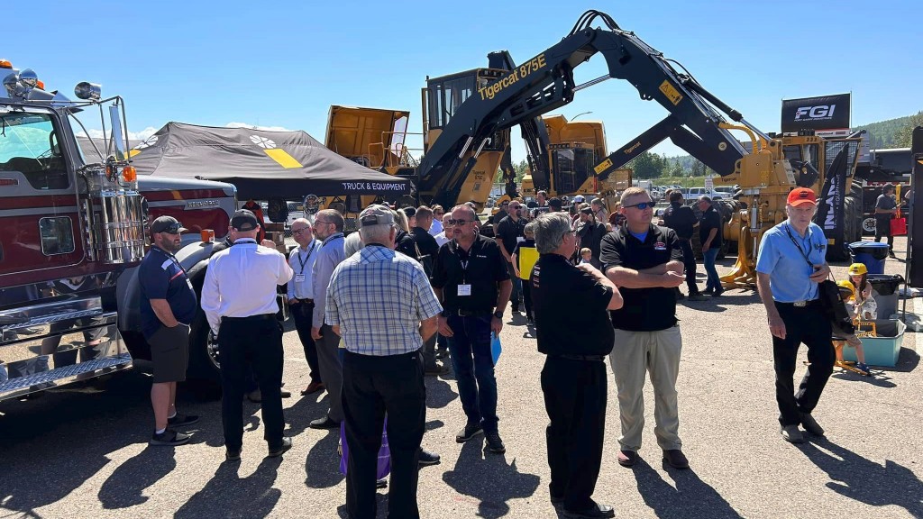 People mill about an outdoor trade show floor