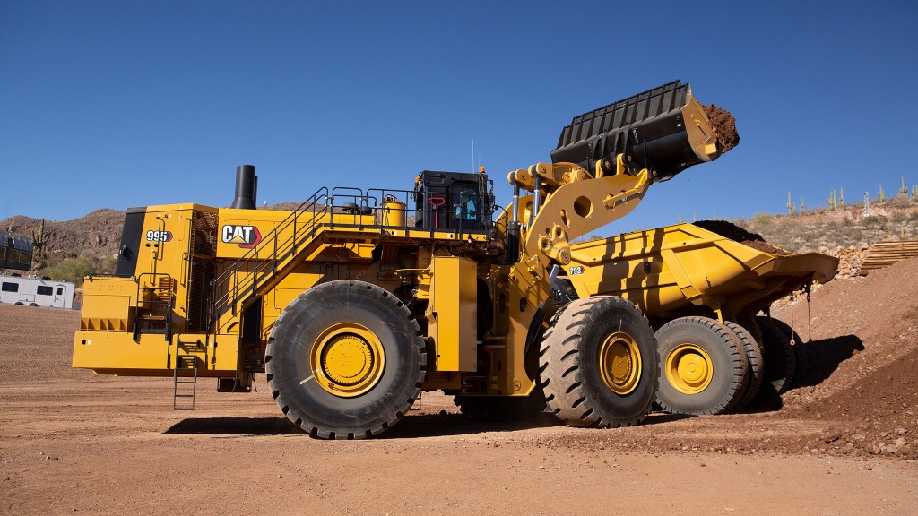 A large wheel loader loading a mining truck.