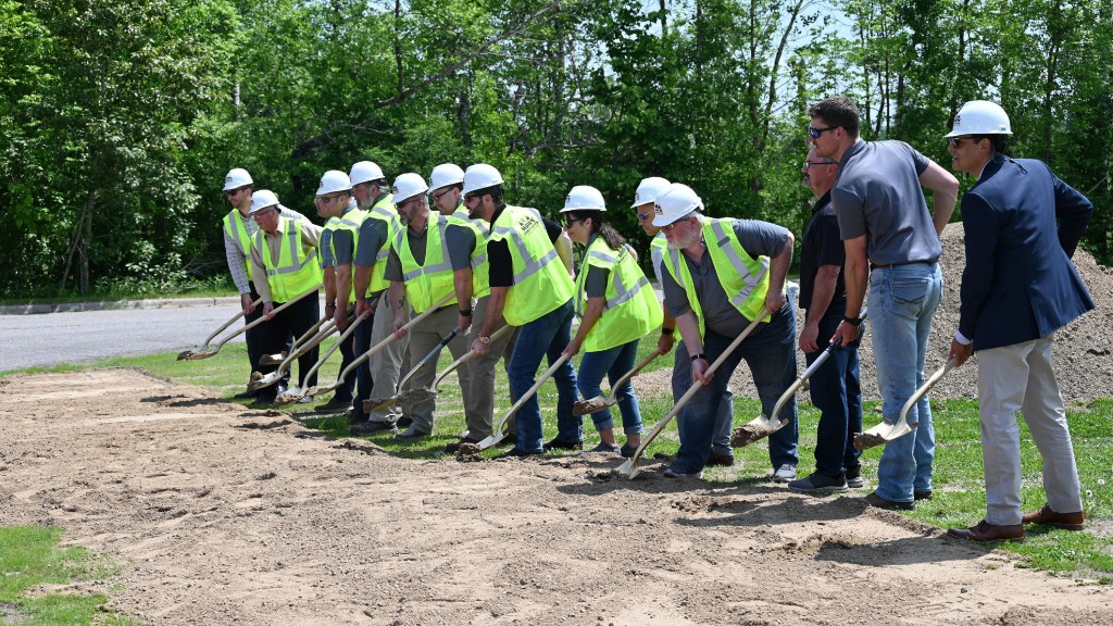 A line of people break ground on a new building
