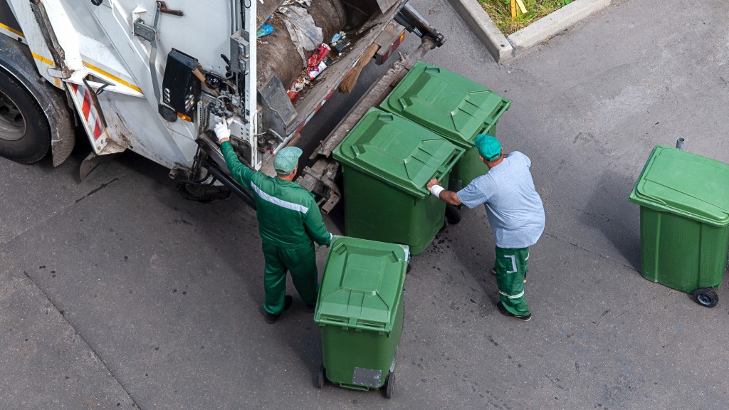 Collection operators empty a garbage bin into a truck