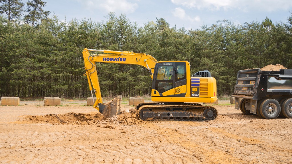 An excavator digs a hole on a job site