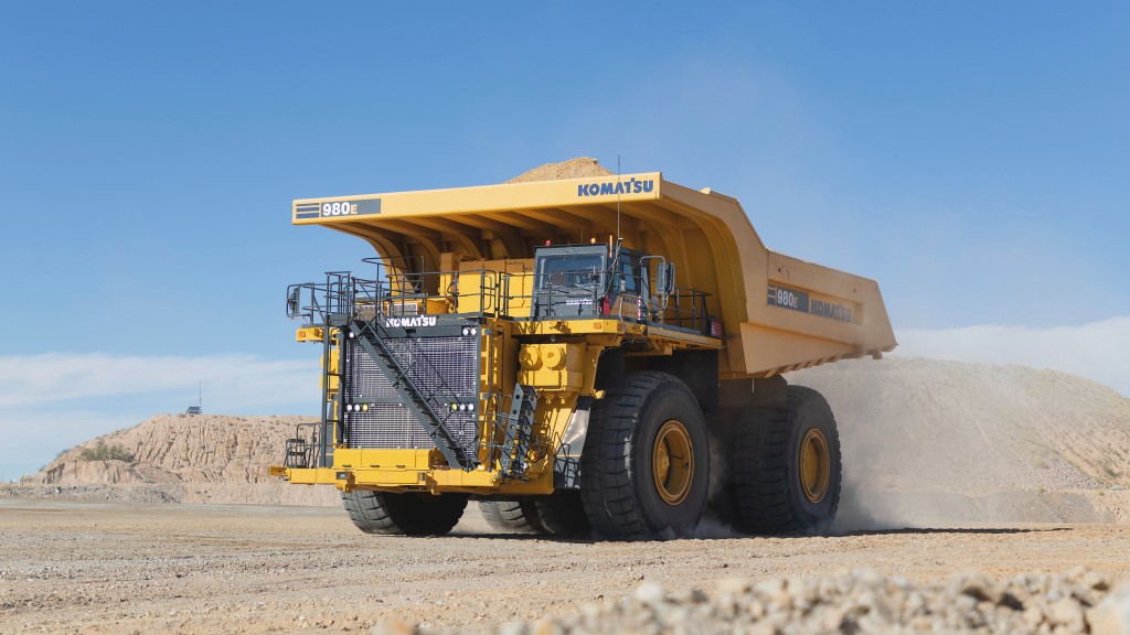 A mining truck drives down a dirt road