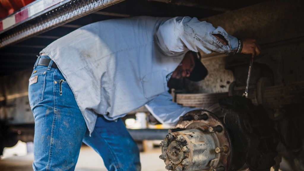 A technician performs maintenance tasks on a vehicle