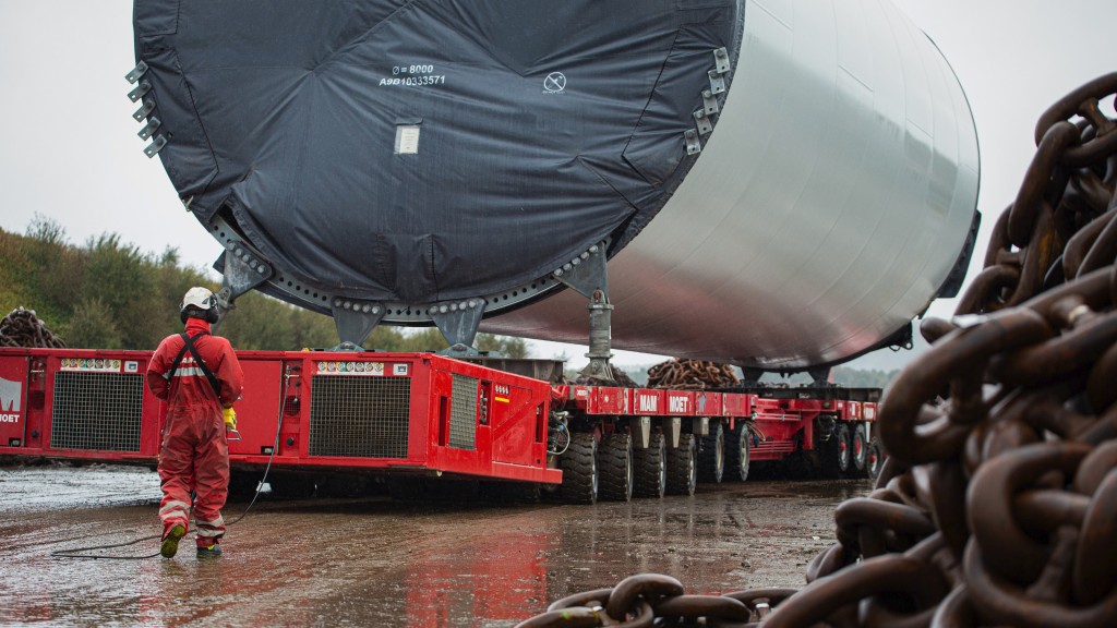 A heavy transport vehicle moves wind farm components