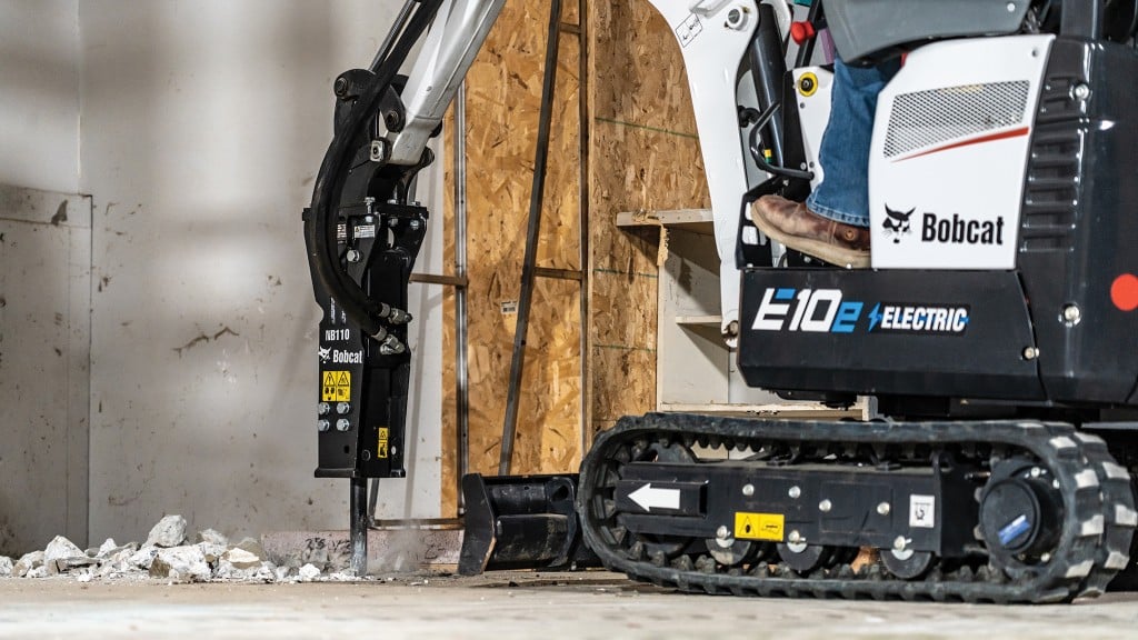 An electric excavator uses a breaker for indoor demolition