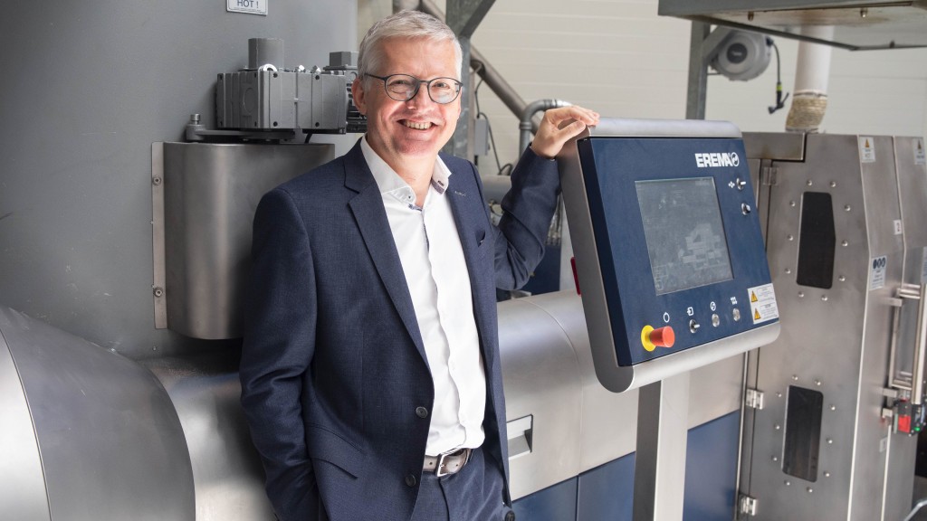 Manfred Hackl stands near an extruder