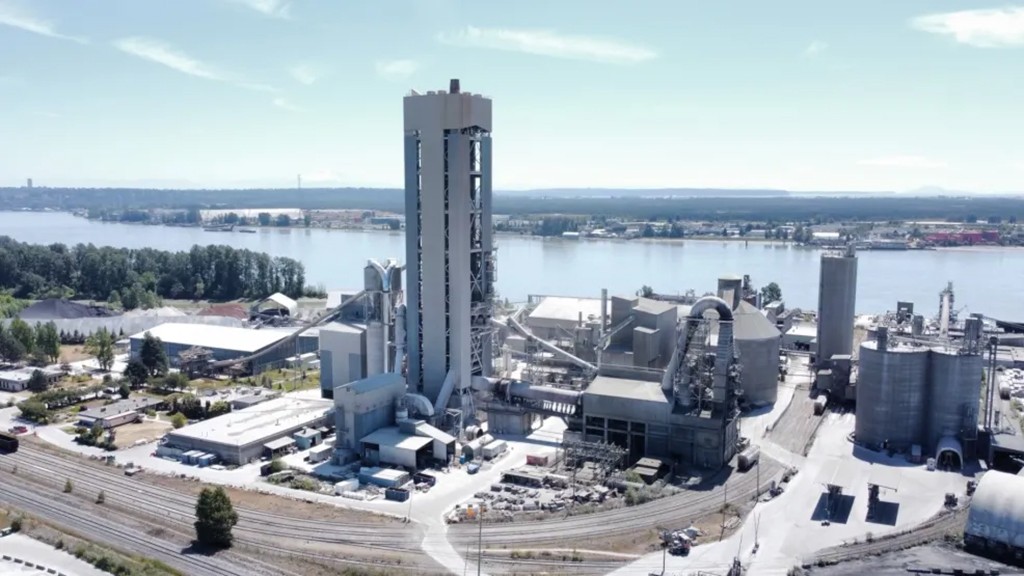 An aerial view of a cement plant next to a river