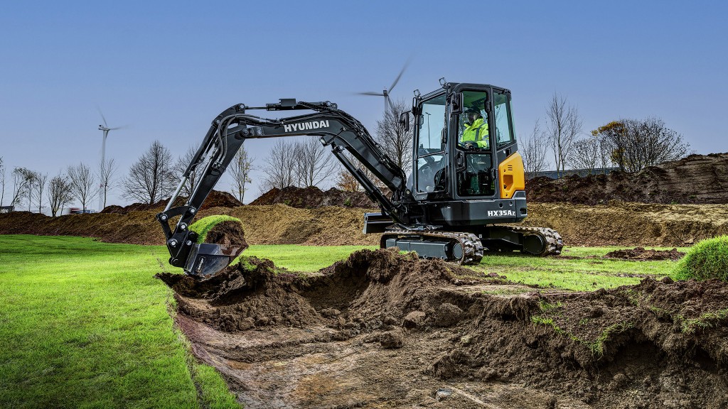A compact excavator working in dirt.