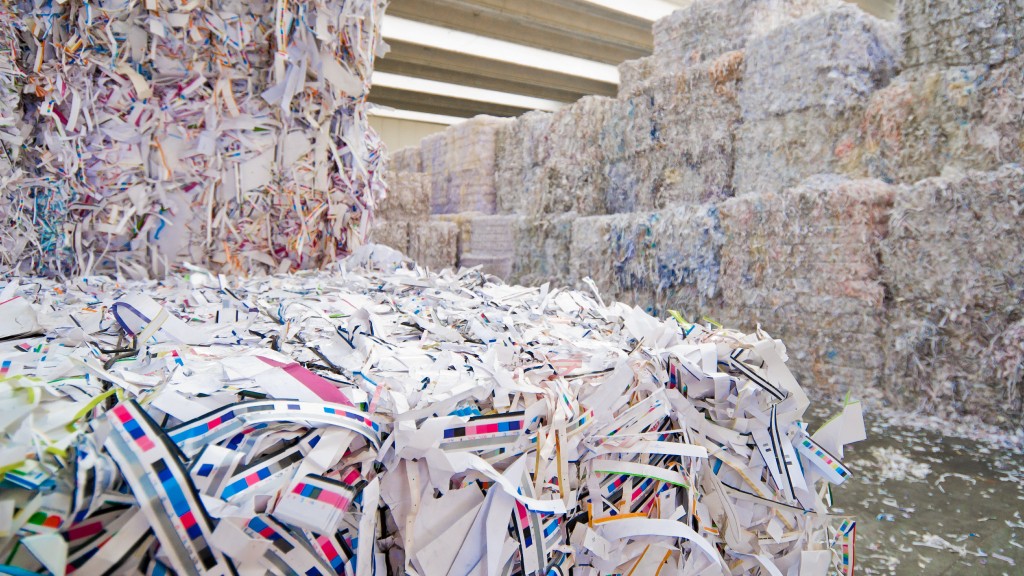 Bales of shredded paper are stored inside a facility