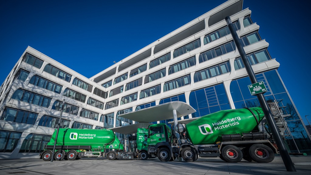 Aggregate and cement trucks in front of an office building.