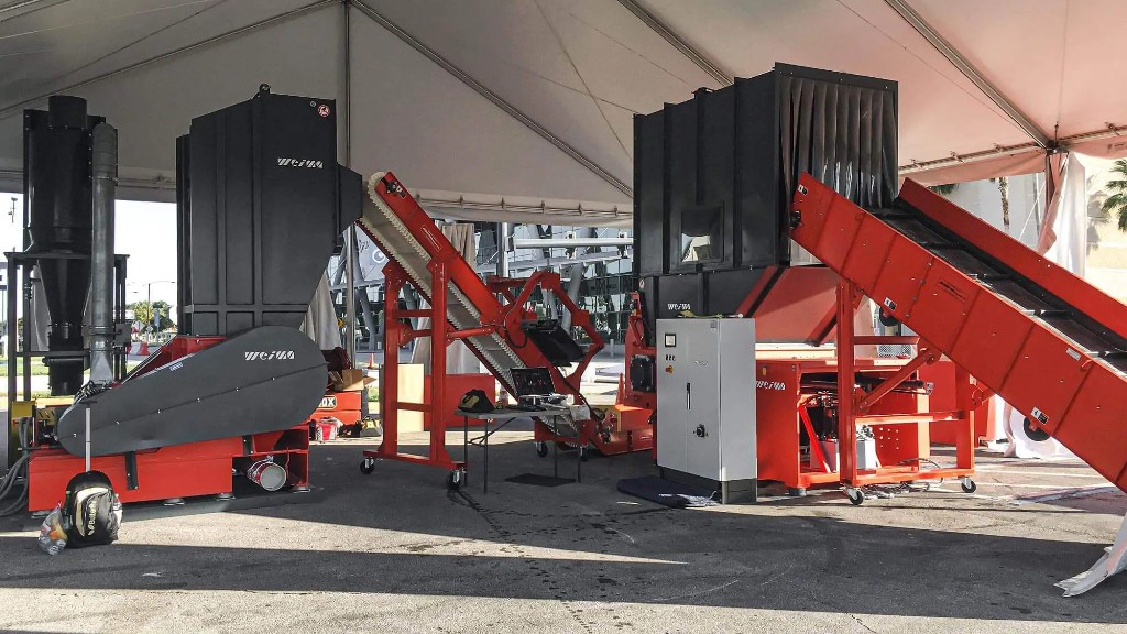 A trade show booth processes plastic scrap