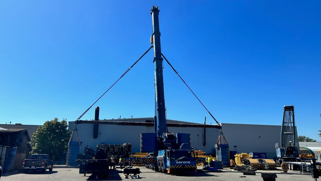 A crane being used for load testing next to a building.