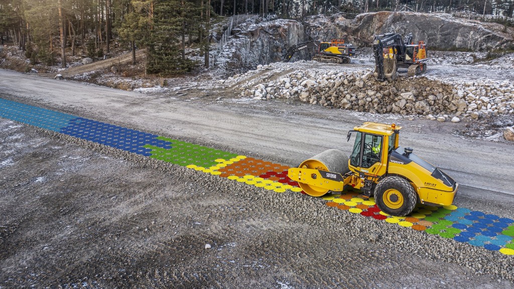 A compactor rolls over dirt on a job site