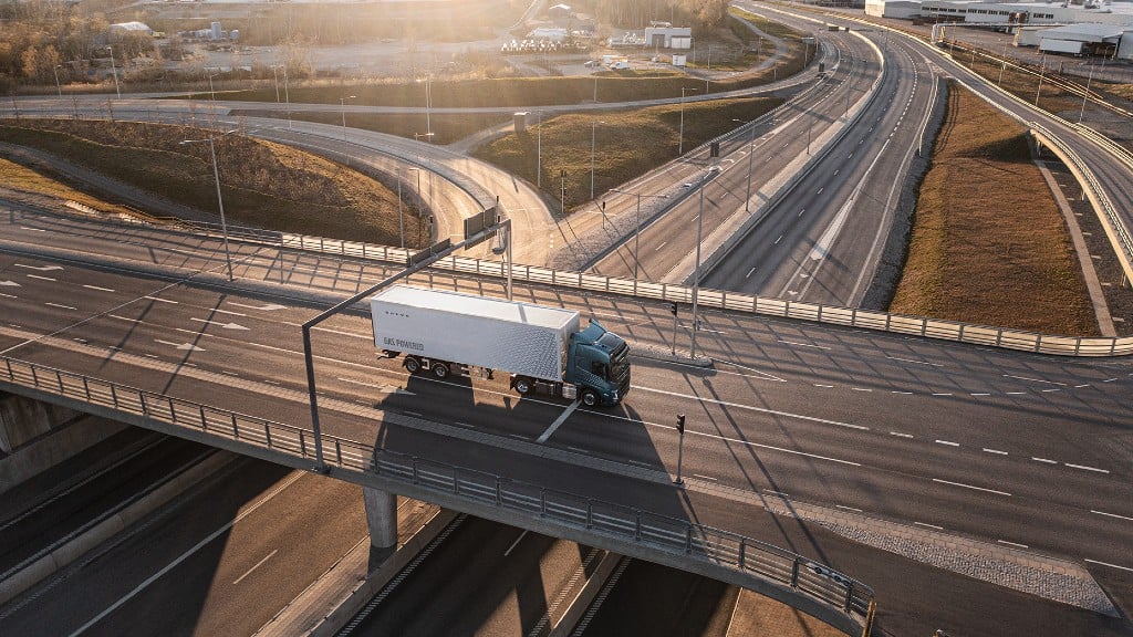 A commercial truck drives an overpass