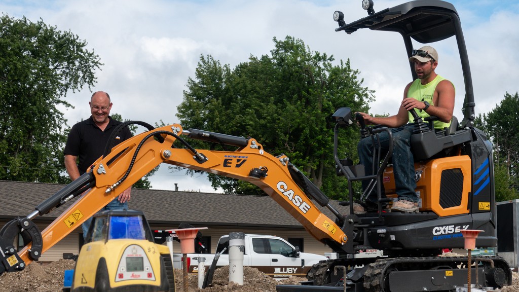 An electric mini excavator working on a job site.