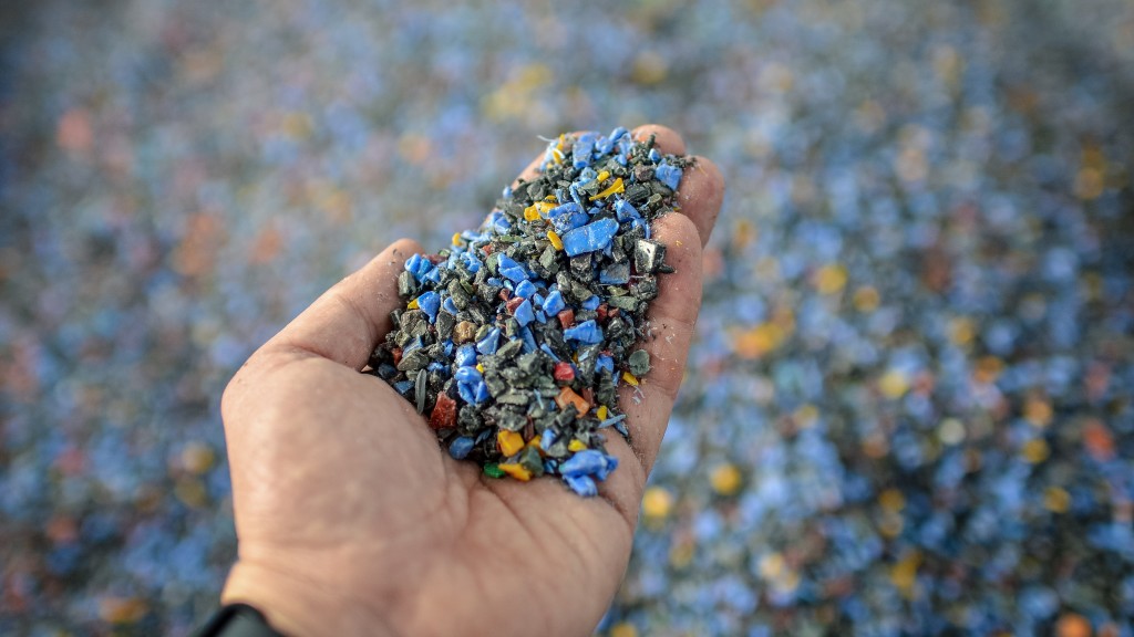 A hand holds fragments of plastic