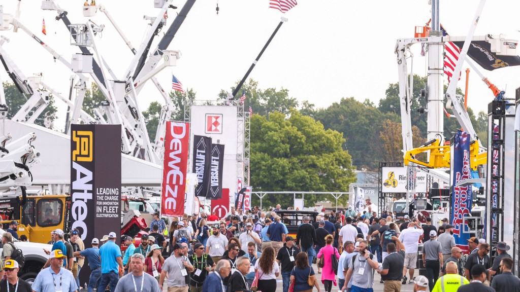 People wander through outdoor tradeshow exhibits