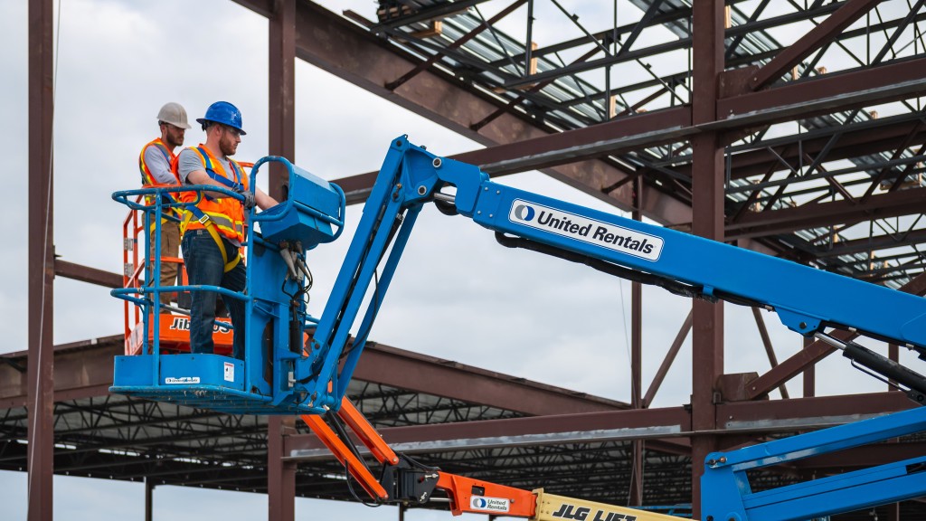 Two lift operators work on a job site