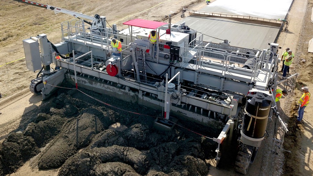 An overhead view of a slipform paver placing concrete.