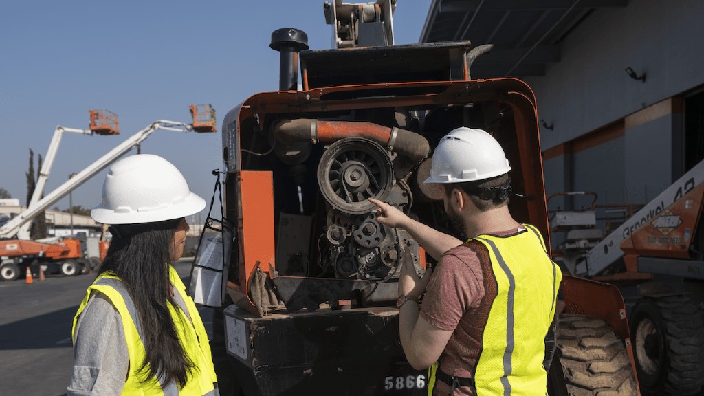 Technicians work to install IoT capabilities into a machine in the field.