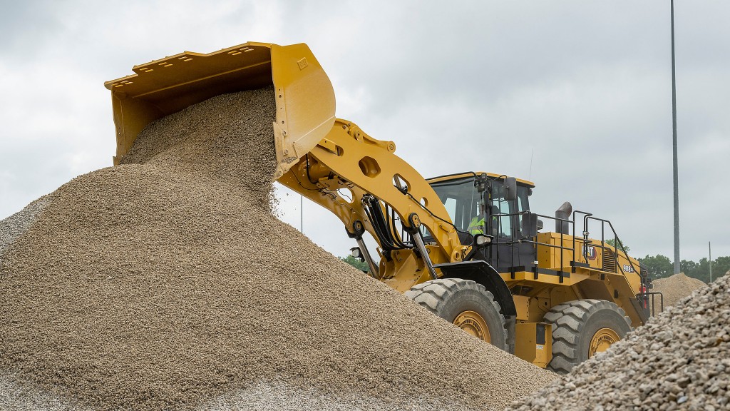 A wheel loader dumps gravel onto a pile.